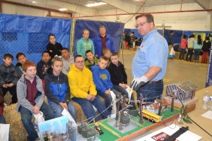 A Benton REA employee demonstrates electrical safety to a group of elementary school students