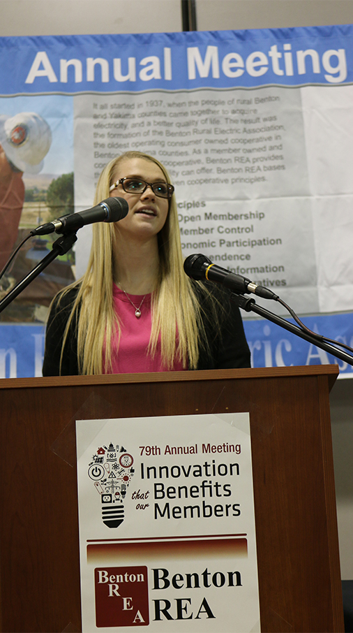 A scholarship recipient reads her winning essay at the Benton REA Annual Meeting