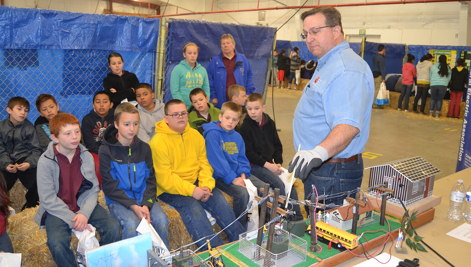 A Benton REA employee demonstrates electrical safety to a group of elementary school students