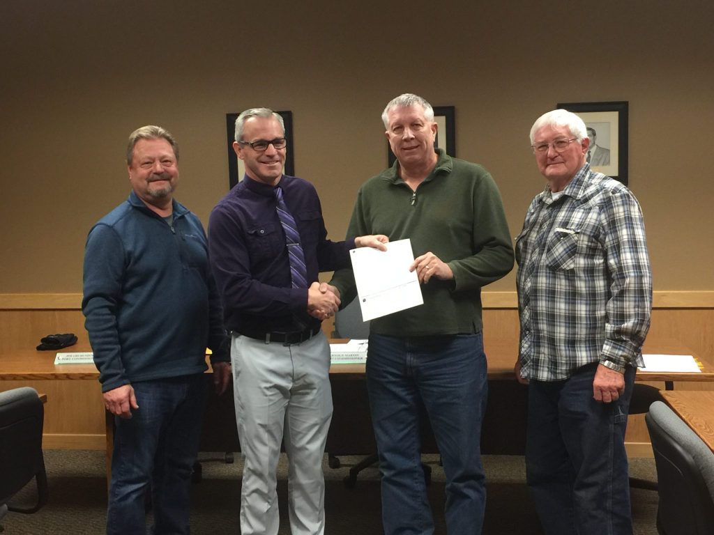Port of Sunnyside Commissioners Jim Grubenhoff, Jeff Matson and Arnold Martin accept a check of $100,000 from Benton REA's Community Development and Member Relations Manager Troy Berglund, second from left.