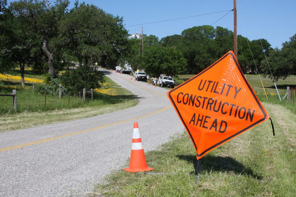 Warning Sign near the side of a road - Utility Construction Ahead