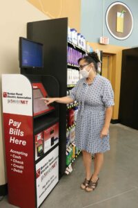 A woman uses the Benton REA and PowerNET kiosk at Prosser's Lep-Re-Kon Harvest Foods. 