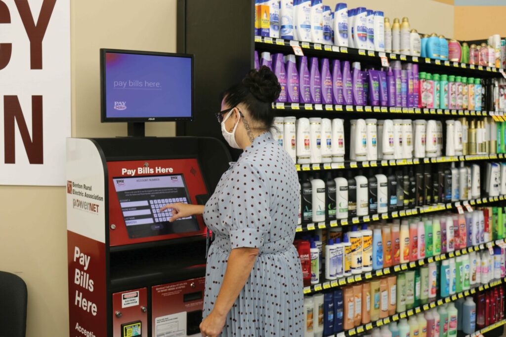 A woman uses the Benton REA and PowerNET payment kiosk at Prosser's Lep-Re-Kon Harvest Foods.
