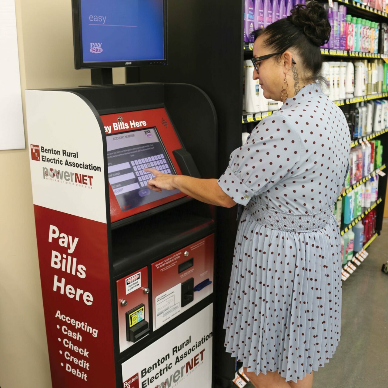 A woman uses the Benton REA and PowerNET kiosk at Prosser's Lep-Re-Kon Harvest Foods.